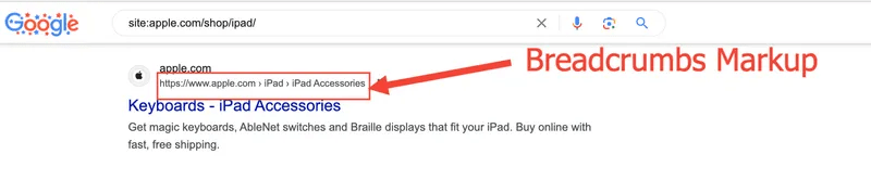 A desktop screenshot showing a portion of a Google search results page for the query site:[apple.com/shop/ipad/](https://apple.com/shop/ipad/). It displays a search listing snippet with the blue title "Keyboards - iPad Accessories".

Above the title, the URL path is displayed as a clean breadcrumb trail, enclosed in a red rectangular frame: [https://www.apple.com](https://www.apple.com) › iPad › iPad Accessories. A red arrow points to this box from the right, positioned next to a large red text overlay that reads "Breadcrumbs Markup".