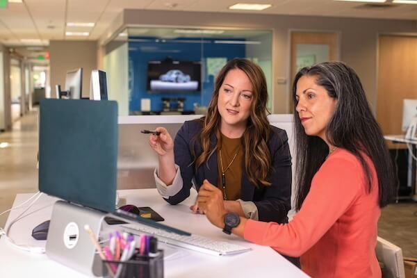 Two women in front of laptop