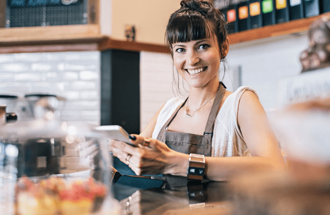 Similing woman working in a cafe